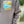Load image into Gallery viewer, Gray hoodie with &#39;Shore Born Supply Co.&#39; graphic on a blurred beach background
